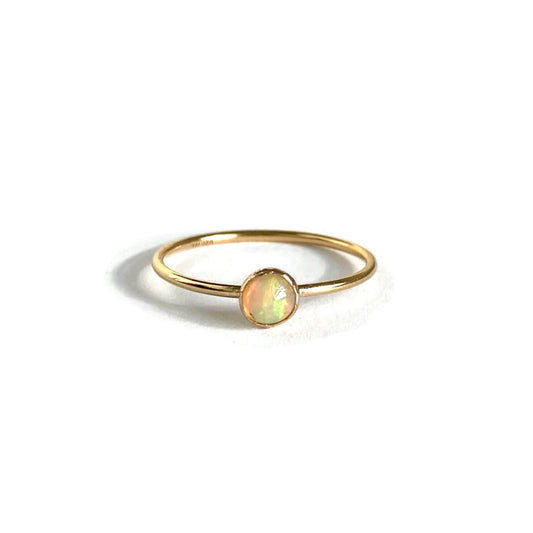 This is a gold opal ring that is made of genuine Opal from Ethiopia with gold filled wire.