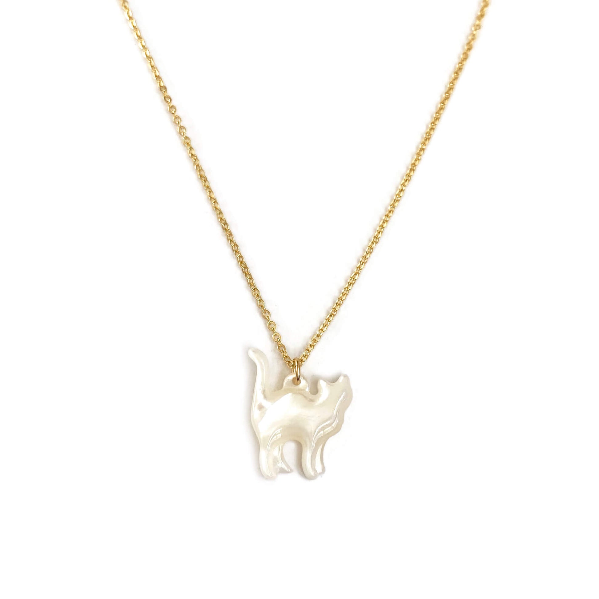 This is a white cat necklace that is made of mother of pearl on a 14k gold chain. 