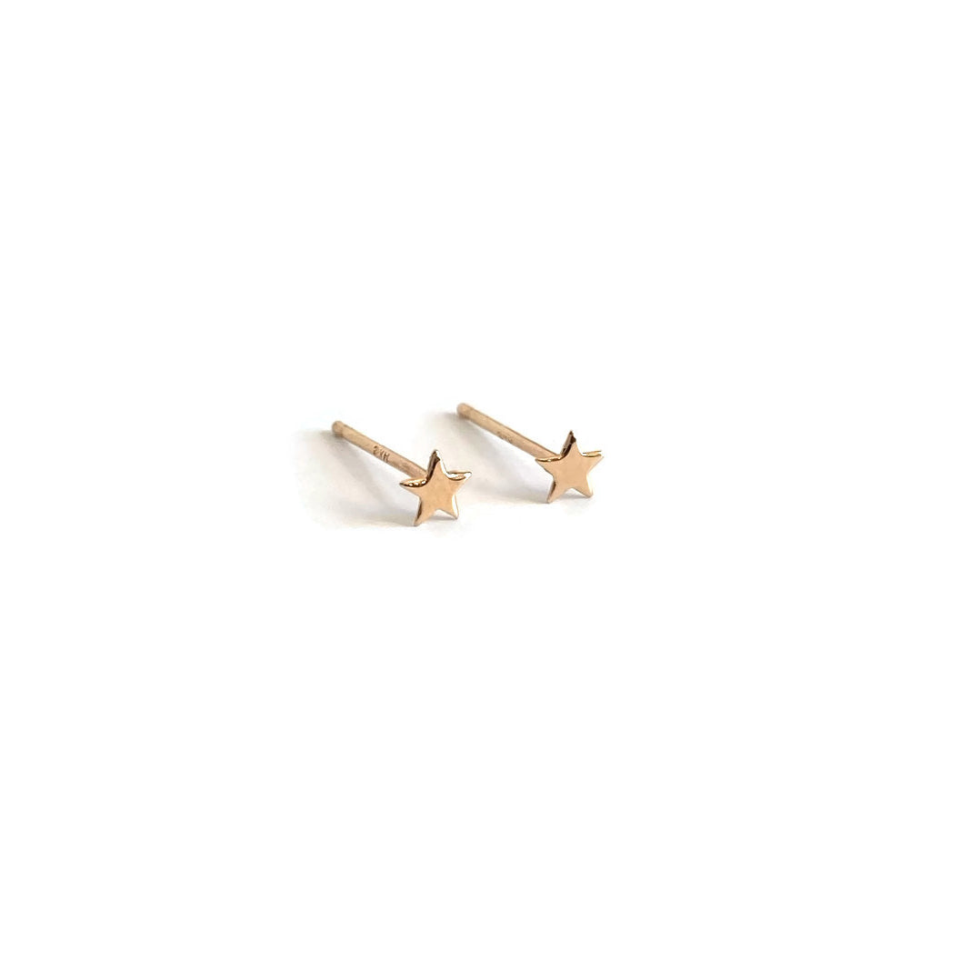 small 14k gold stud earrings feature tiny gold star earrings.
