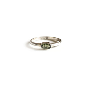 This is a dainty moldavite ring that is made of genuine faceted Moldavite and sterling silver.