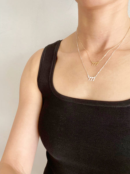 There are 2 of 777 necklaces on the model. One is a 16" gold 777 Angel number necklace and a sterling silver 777 Angel number necklace that is made of sterling silver chain.