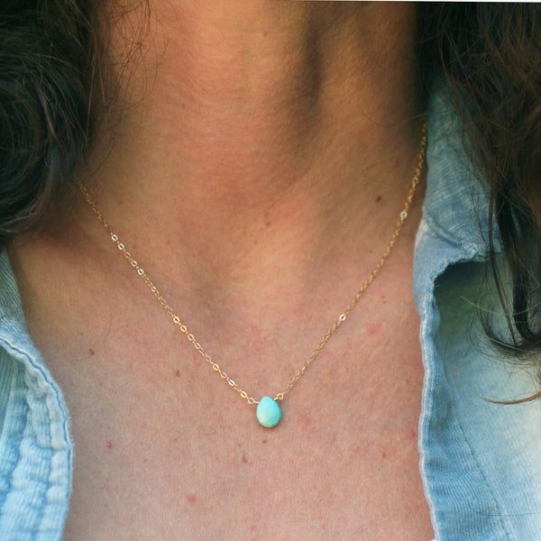 Dainty turquoise necklace is made of a single real turquoise gemstone and 14k dainty gold chain. The model is wear it at 18 inches.