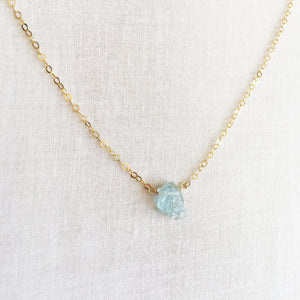 This is a Raw Aquamarine necklace that's made of 14k gold chain and raw Aquamarine. 