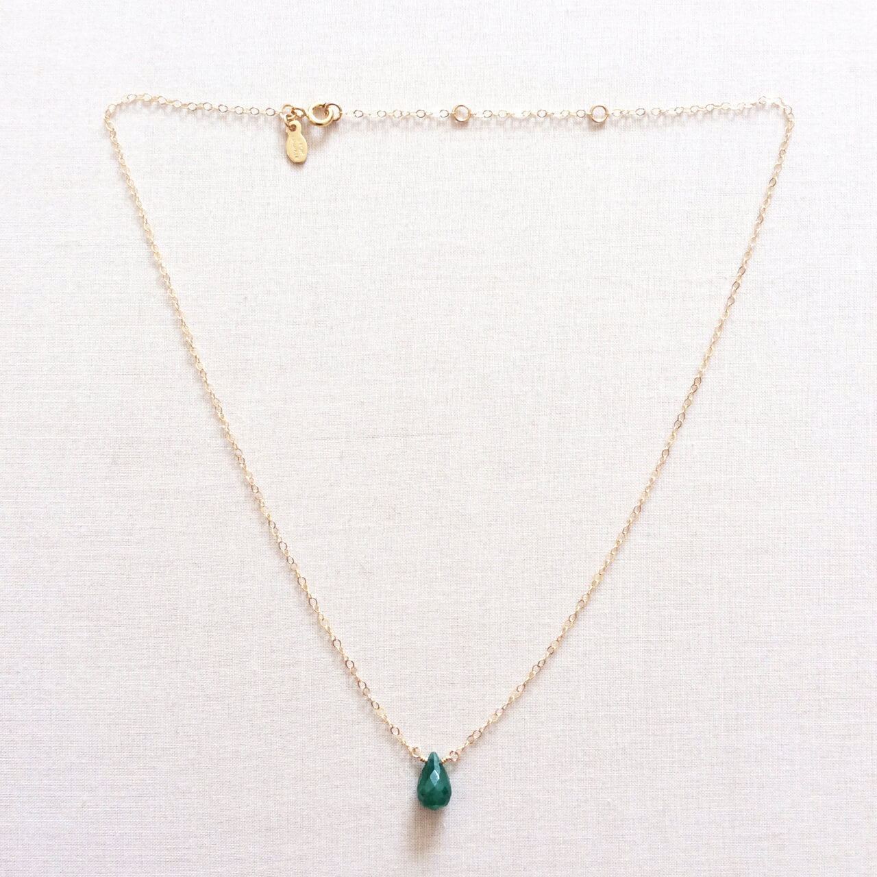 Real emerald necklace is made of adjustable chain.  It's one of the best selling meaningful birthstone necklaces. 