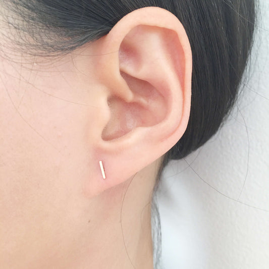 This tiny bar stud earring is made of solid 14k gold. for pierced ear. Since it small and dainty you can layer it with other gold stud earrings you have multiple ear pierced. 