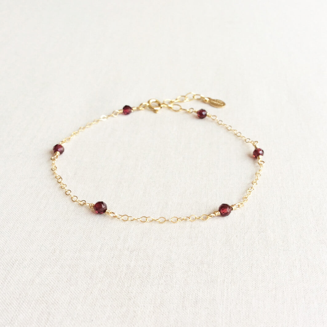 This is a 14k gold garnet bracelet with adjustable chain in 14k or gold filled