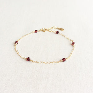 This is a 14k gold garnet bracelet with adjustable chain in 14k or gold filled