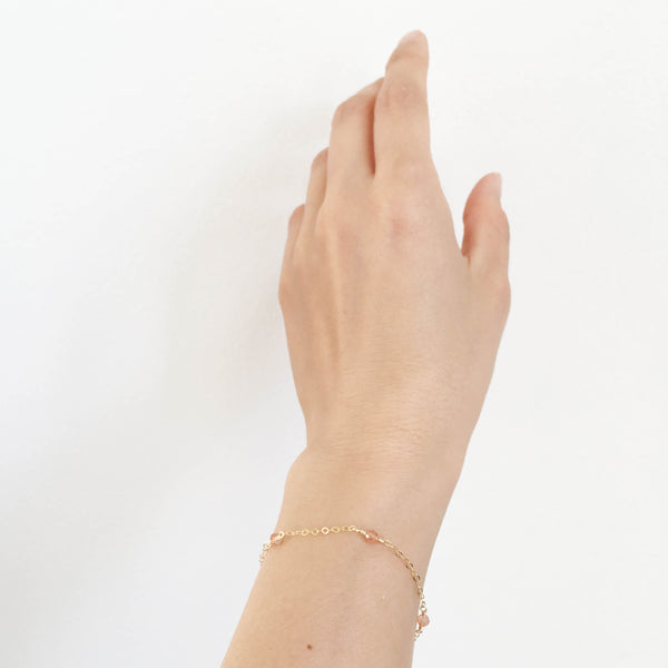 This sunstone bracelet is dainty and delicate. It's made of 14k gold chain and real sunstone beads.