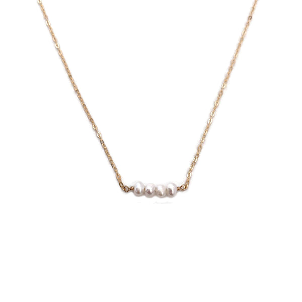 The dainty pearl bead necklace is simple and dainty.  It's made of 14k gold chain with four fresh water pearl beads. 