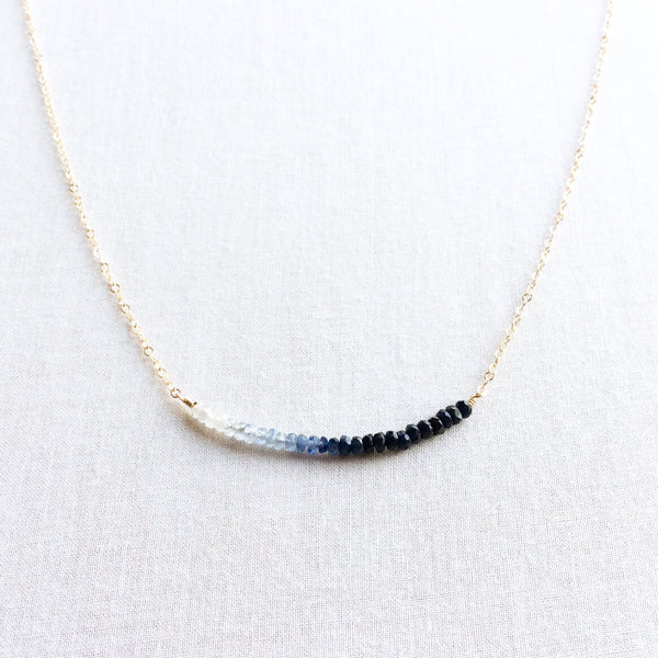 The ombre sapphire necklace is one of our customers favorite pieces because it is perfect for layering, or as a standalone piece.  We hand select genuine blue sapphires that vary in shade starting with very light blue to the deepest navy, and string them so that they are in order from light to dark.  