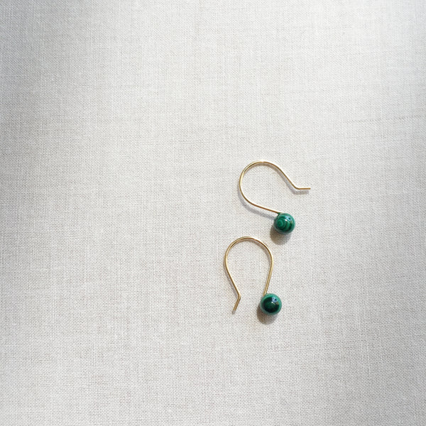 There are simple and dainty earrings made of Malachite gemstone beads. 