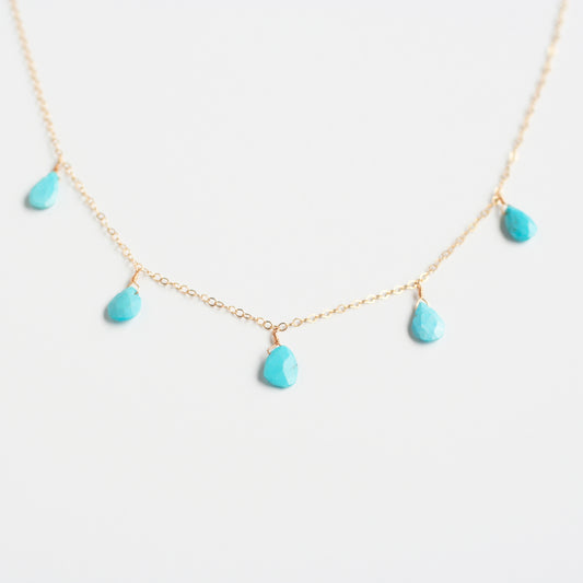 This dangling turquoise necklace is made of real turquoise beads and 14k gold chain.