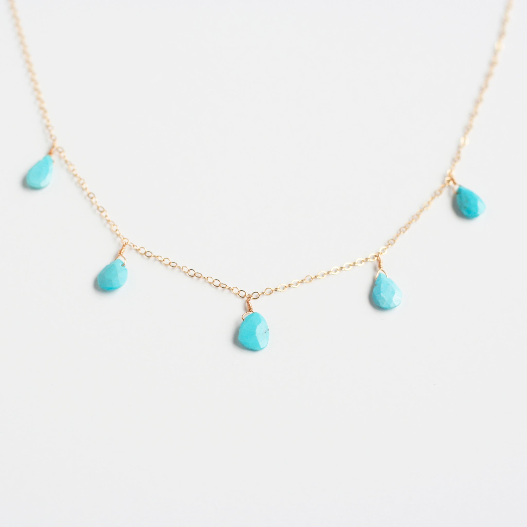 This dangling turquoise necklace is made of real turquoise beads and 14k gold chain.