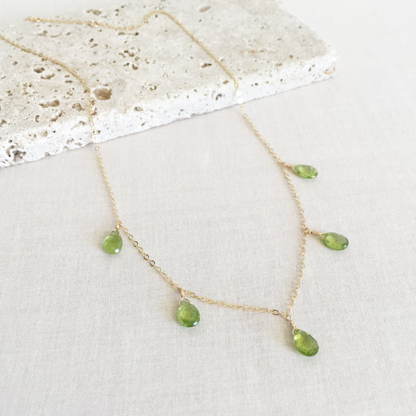 This peridot necklace is made of 5 real peridot gemstones and 14k gold chain. 