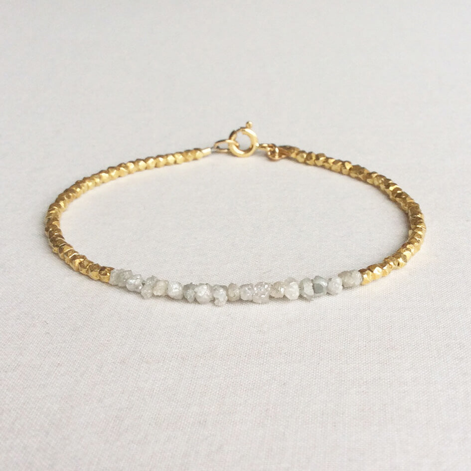 This raw diamond bracelet is made of genuine rough diamonds and 24k gold vermeil beads. They are 7 inches long and will fit a standard size wrist. 