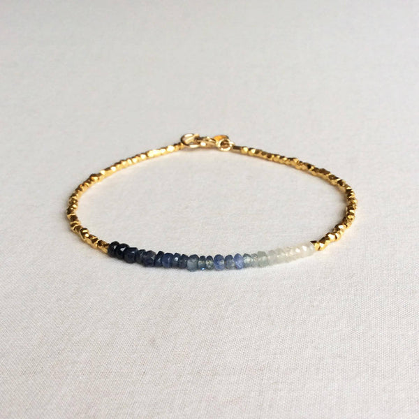 this ombre sapphire bracelet exudes a timeless look.  The bracelet is made with hand-selected sapphires that have different shades of blue – from nearly white to deep navy blue. 