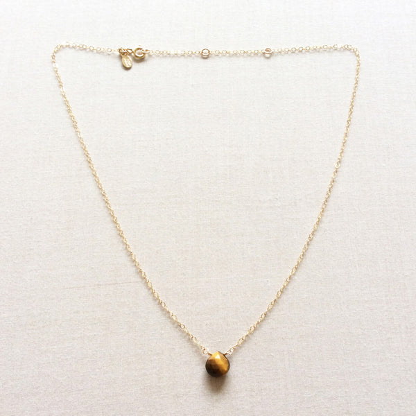 This tigers eye necklace is constructed in our San Francisco studio and available with a 14k gold, gold fill or sterling silver chain.