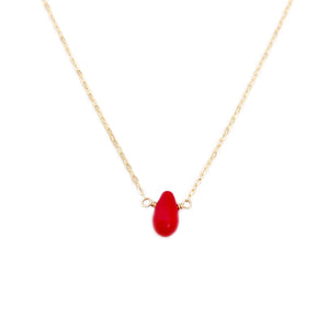 This dainty red coral necklace is made with a single piece of red coral gemstone - a brighter shade of red compared to a ruby.   Perfect for a more casual and fun look, the chain for this necklace can be made in several different materials. 