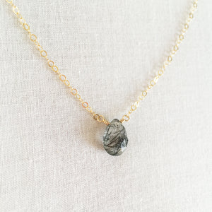 this black rutilated quartz necklace is made with a single gemstone called black rutilated quartz.  This healing quartz necklace has unique black lines through it caused by naturally occurring minerals inside the quartz stone. 