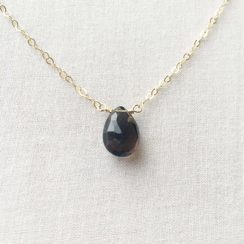 This smoky quartz gold necklace features a single grey gemstone attached to a 14k gold, gold fill or sterling silver chain. 
