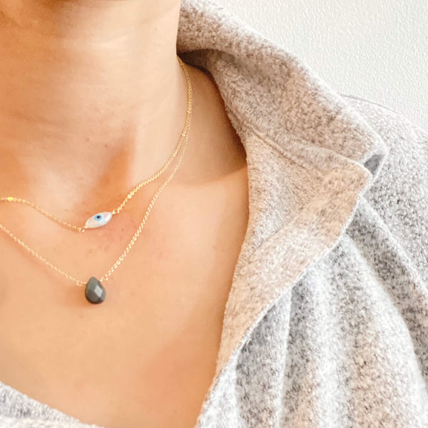 This is an evil eye necklace layering with an obsidian necklace to protect the wearer from negativity. 