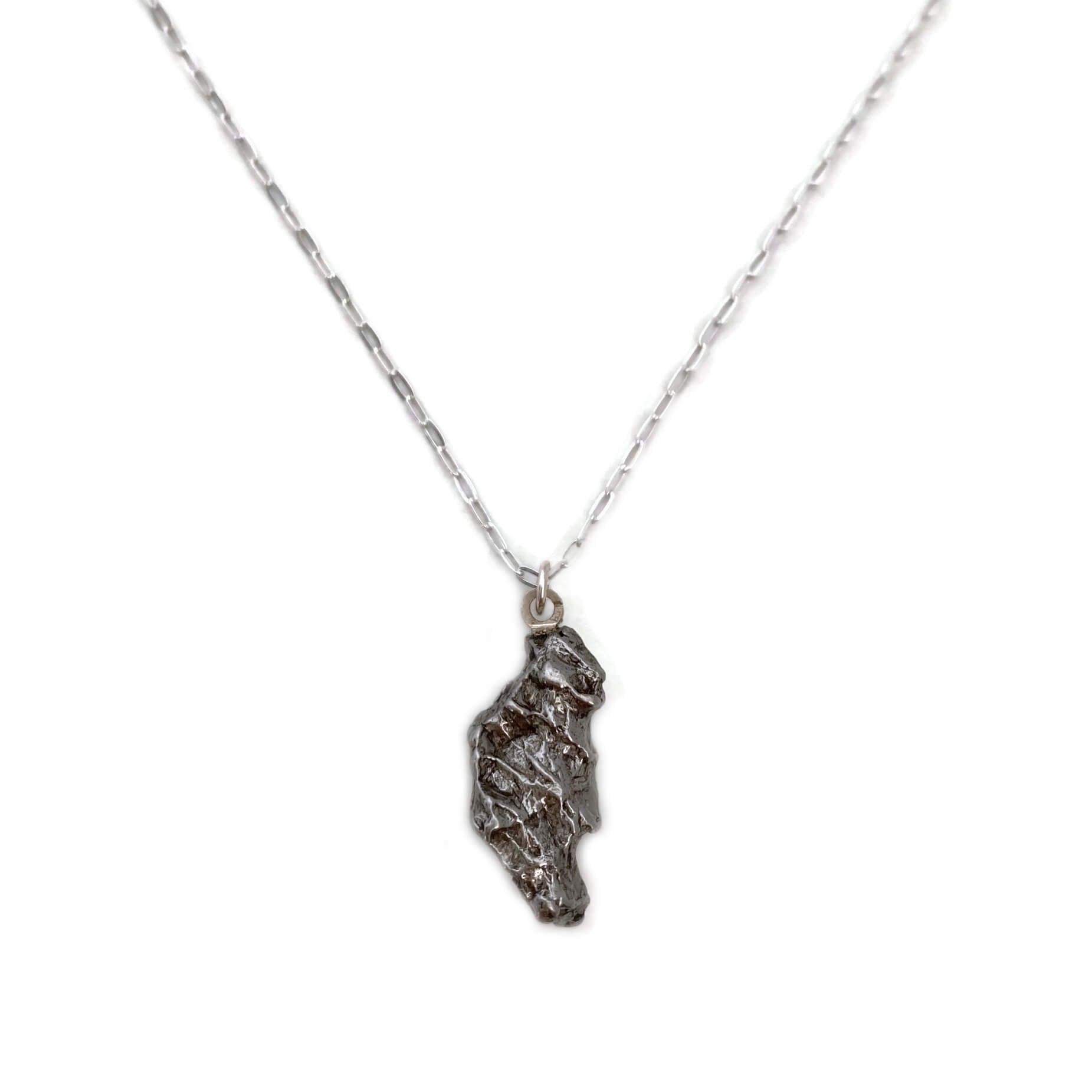 This meteorite necklace is made from a genuine piece of meteorite that crashed to earth near a place called Campo del Cielo in Argentina.  Studies have shown that the meteorite fell to earth around 4,500 years ago in South America. 