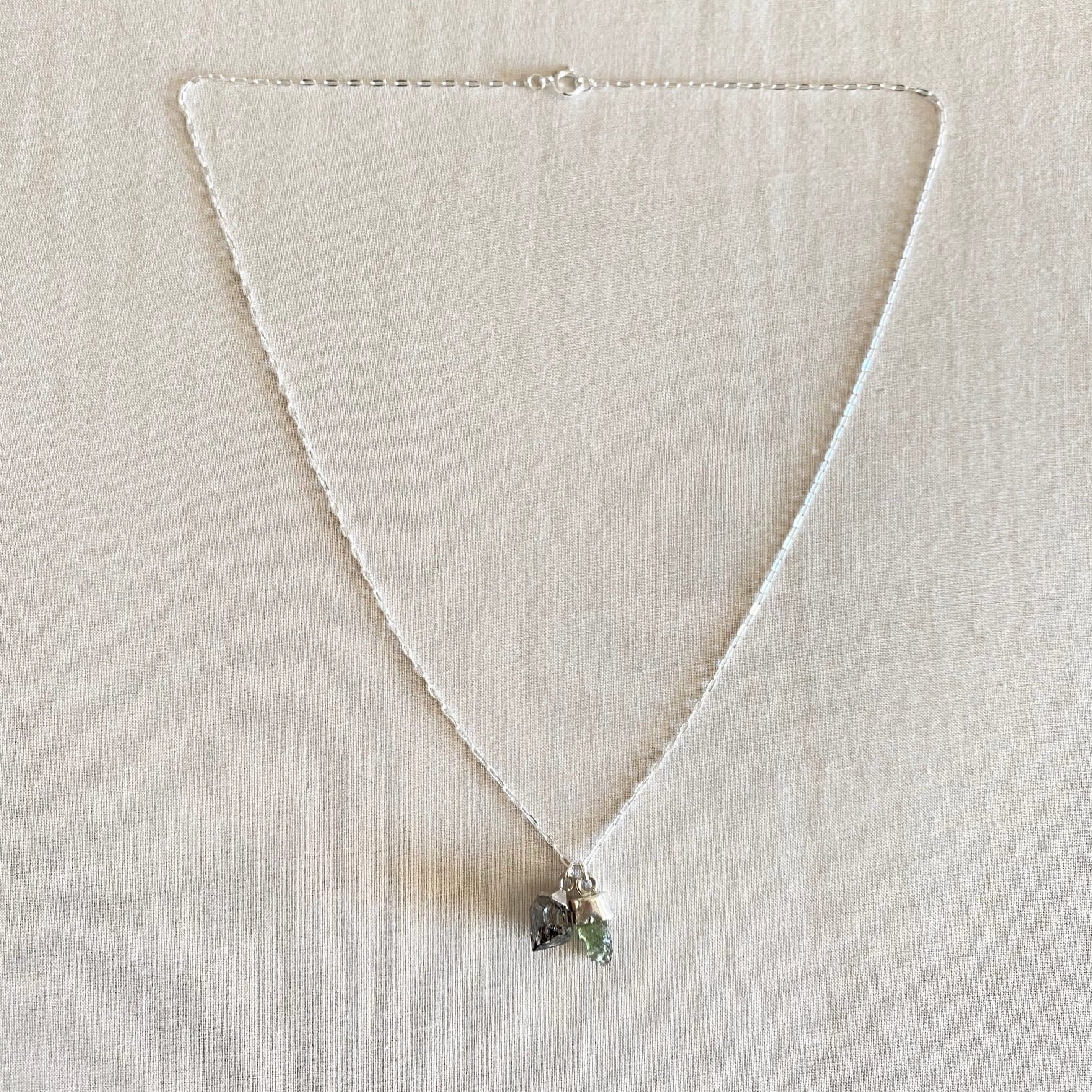 Moldavite and Herkimer diamond necklace is made of sterling silver. 
