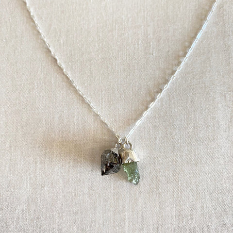 This is a moldavite and herkimer diamond necklace.