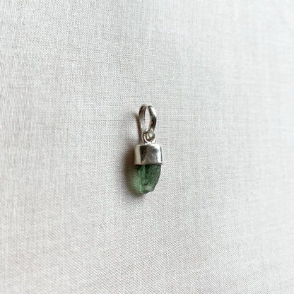 This is a moldavite pendant that is made of genuine Moldavite with sterling silver