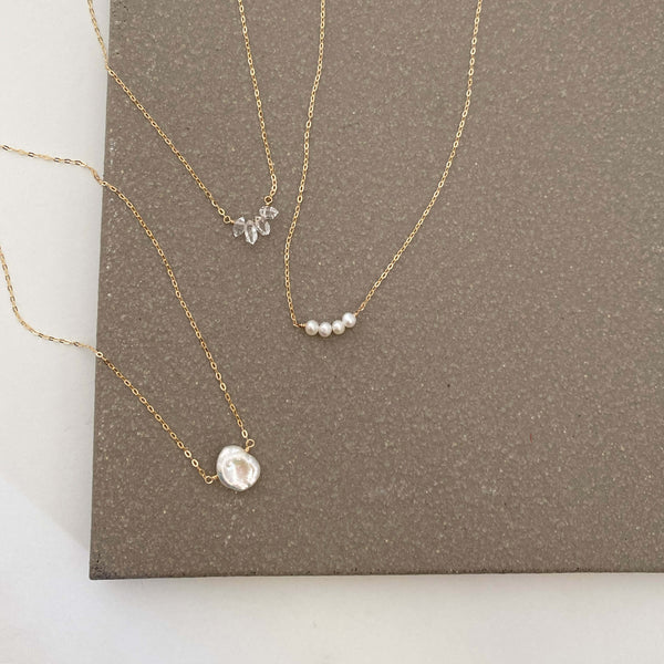 The dainty Herkimer diamond necklace can be made in 14k gold, gold filled or sterling silver chain. They are handmade in san francisco.